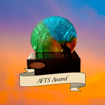 AFTS award being a decorative glass disc of AFTS logo colours blue, green and orange and gold moulded with tree shapes set into a wooden block with a gold engraved disc stating the name of the first winner.